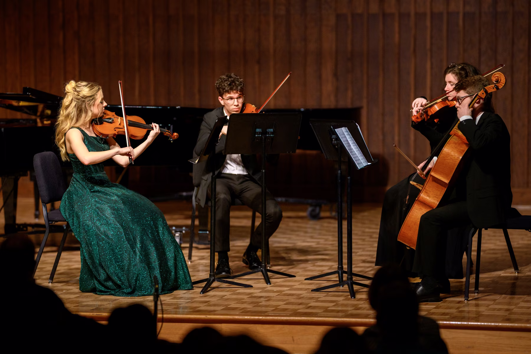 Alyssa seated with fellow musicians during an ensemble performance.